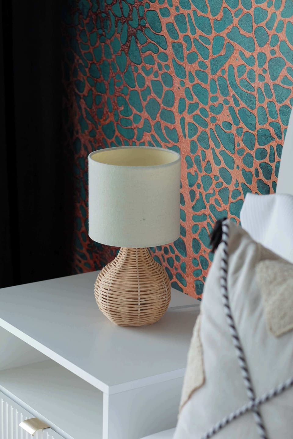 A stylish bedside lamp with a patterned shade. A warm touch to the bedroom decor.