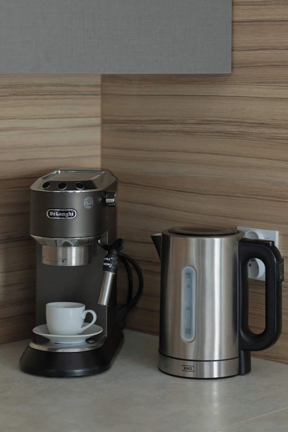 A close-up of a kitchen corner featuring a coffee maker and an electric kettle. Perfect for a morning brew.