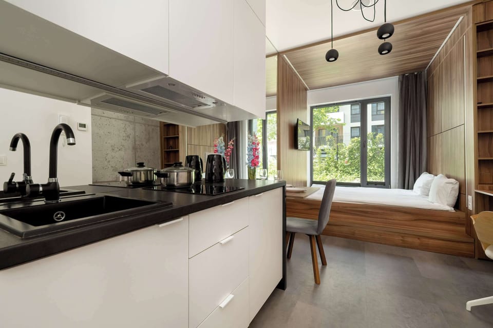 Studio with a double bed, TV and kitchenette.