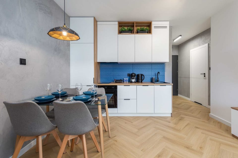 A dining area adjacent to the kitchenette, featuring elegant furniture and pendant lighting for a sophisticated touch.

