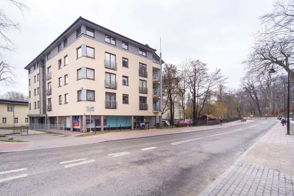  A wide-angle view of the building from the street, highlighting its architecture and surrounding environment.