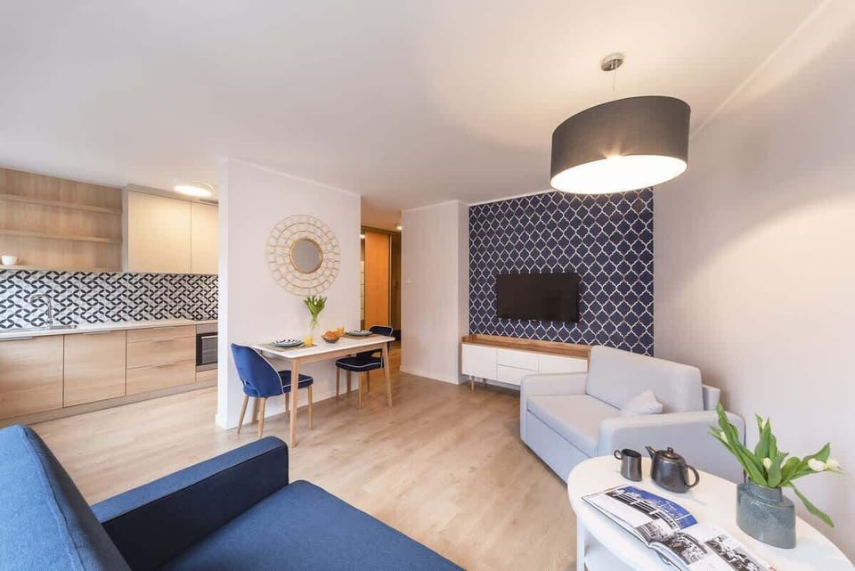 The living room connected to the dining area, emphasizing the harmonious color palette of blues and whites.