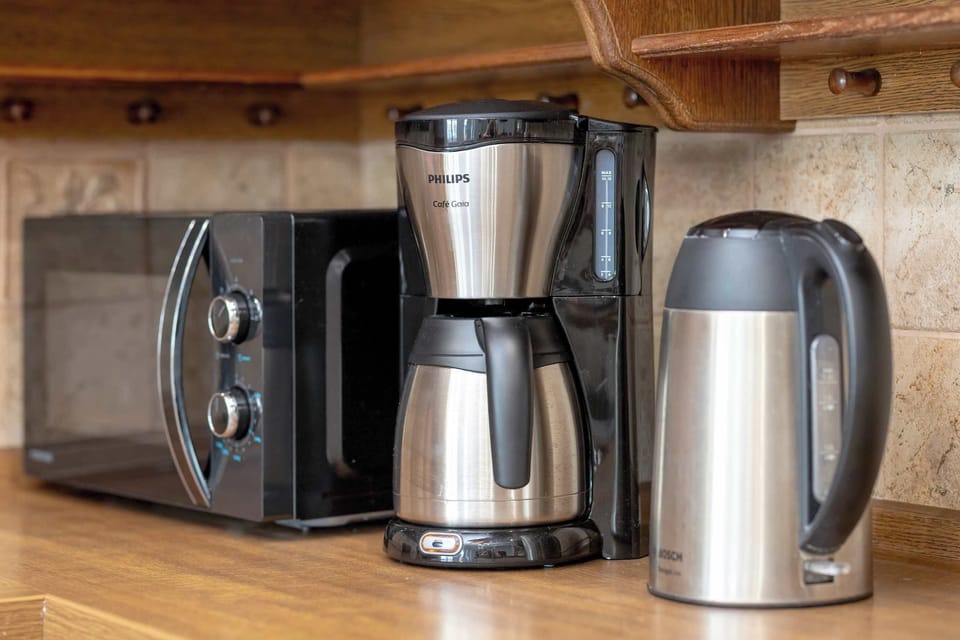 A corner with a coffee maker, electric kettle, and toaster. Perfect for morning routines.