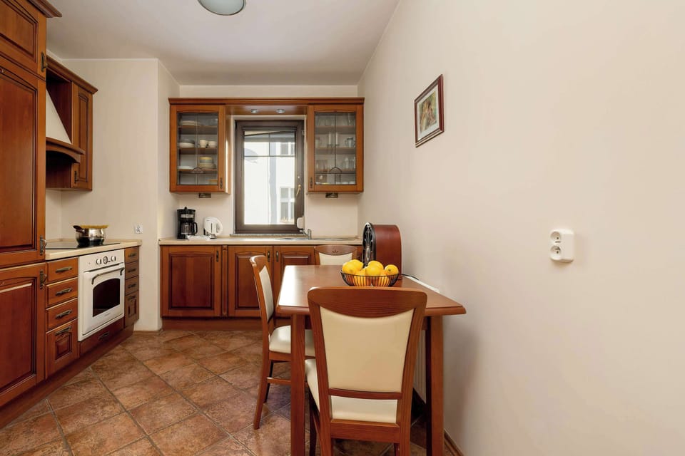 A bright kitchen with classic furniture and quality appliances that ensure home-cooked meals can be prepared.