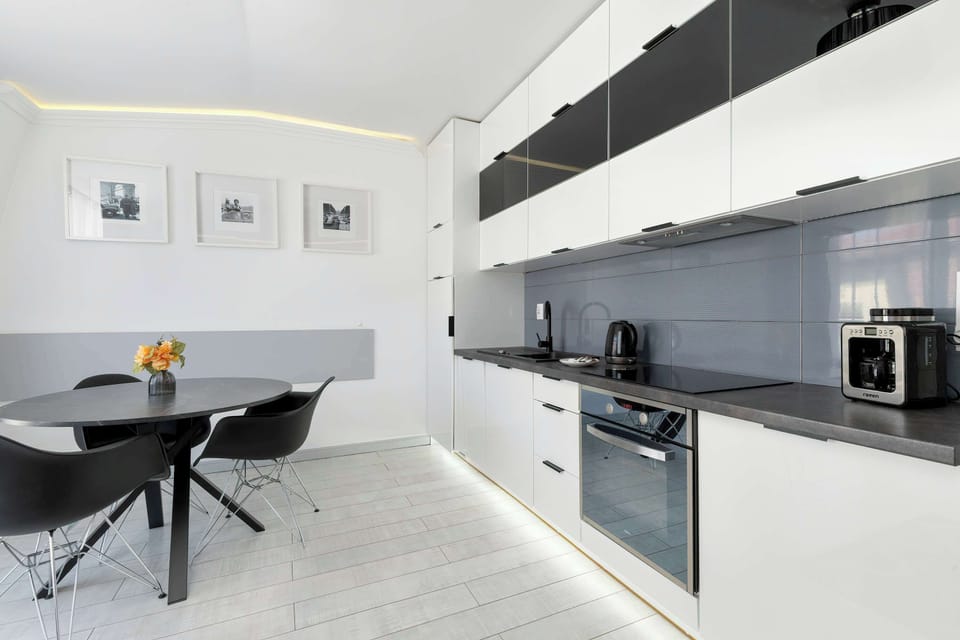 Dining area with a round table and chairs, adjacent to the kitchenette.