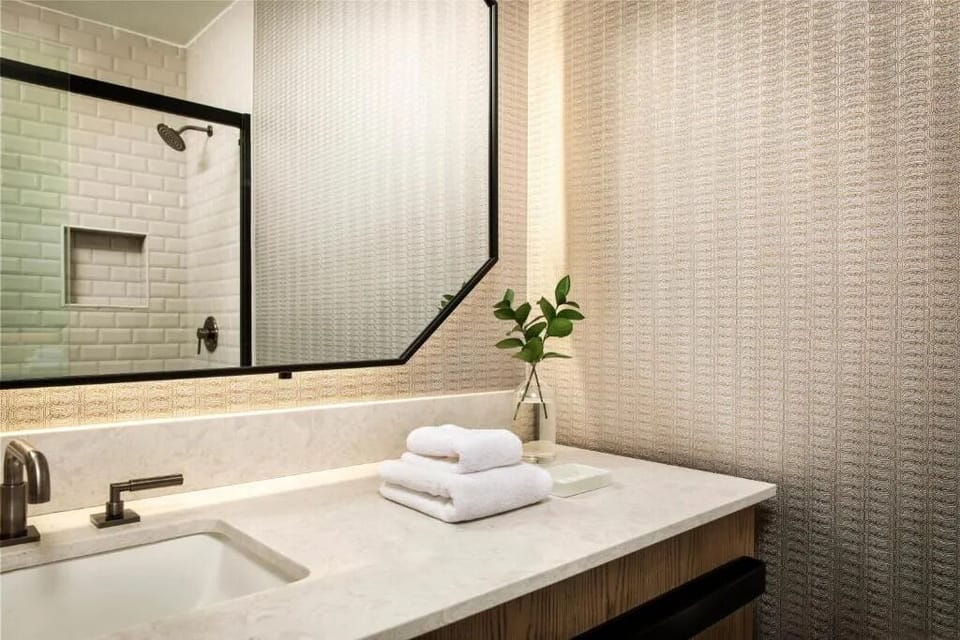 Pamper yourself with bright vanity lighting and fresh towels.