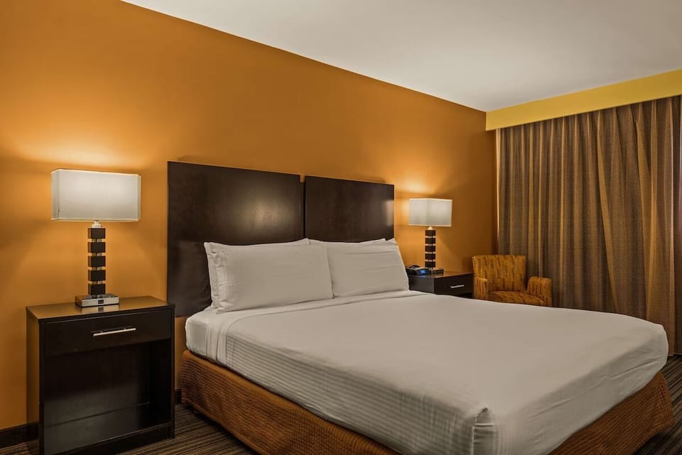 Drift off in serene comfort with softly lit bedside elegance.