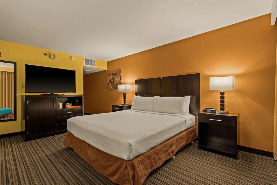 Relax into a quiet night with bedside lamps and plush bedding.