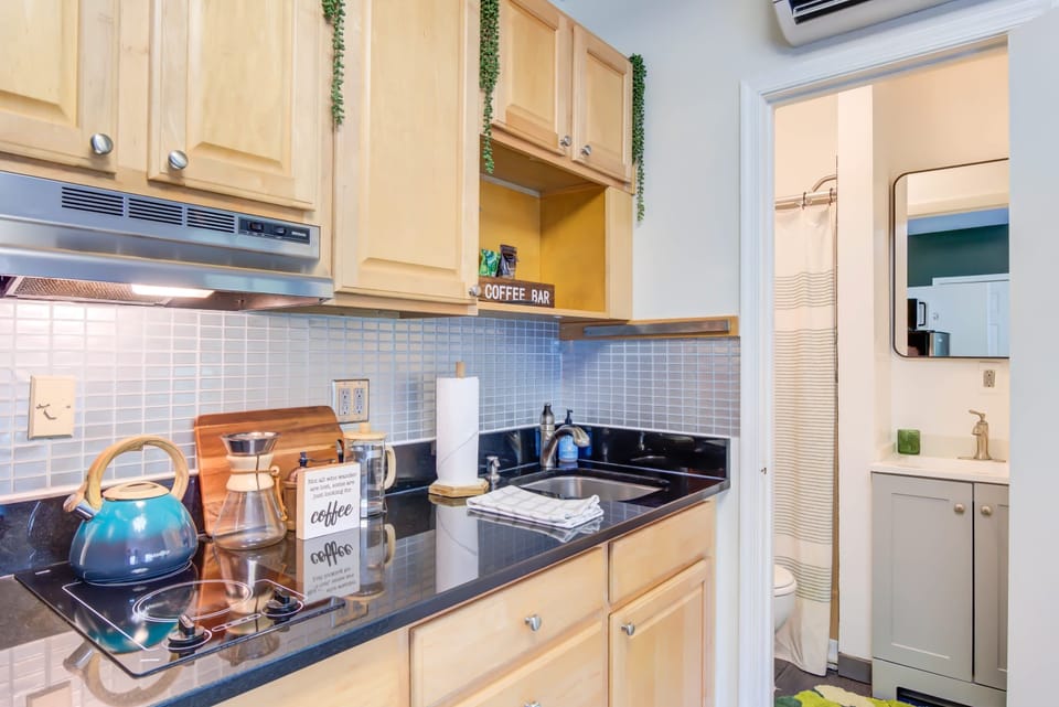 Start your day your way—grind local beans from a nearby historic coffee shop and enjoy a treat in the kitchenette. With the bathroom on the right, every detail of this unique property makes even a simple cup of coffee feel special!