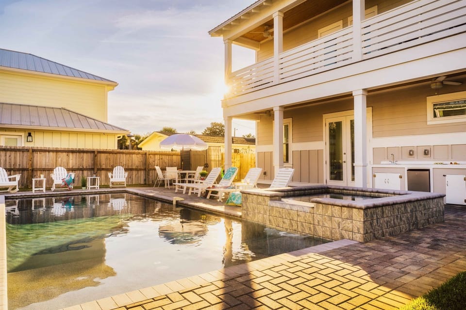 PRIVATE HEATED POOL & HOT TUB: Large Pool and Hot Tub in Private Backyard with plenty of seating and a Covered Outdoor Kitchen + a Fire Pit
