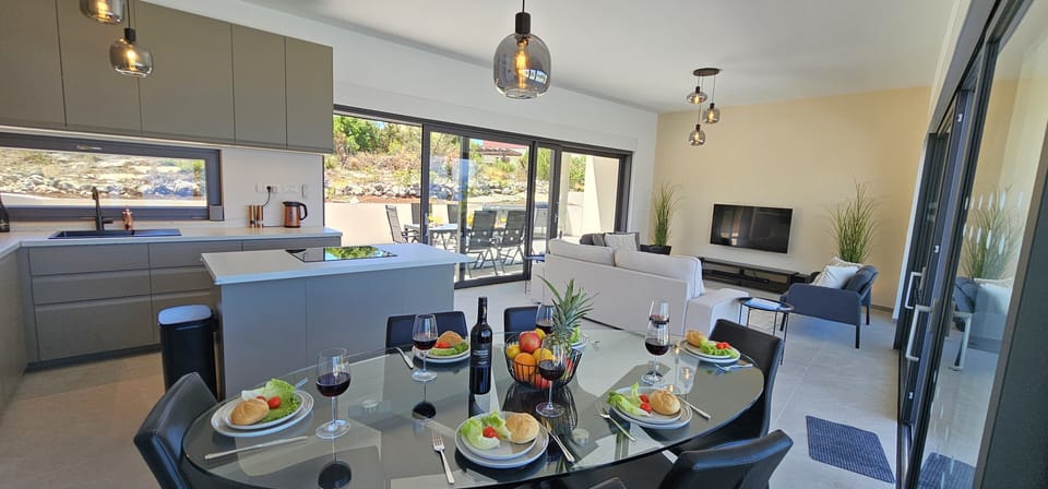 Open plan living dining room opens onto 2 terraces