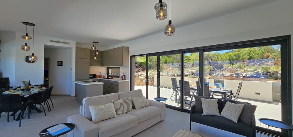 Open plan living dining room opens onto 2 terraces