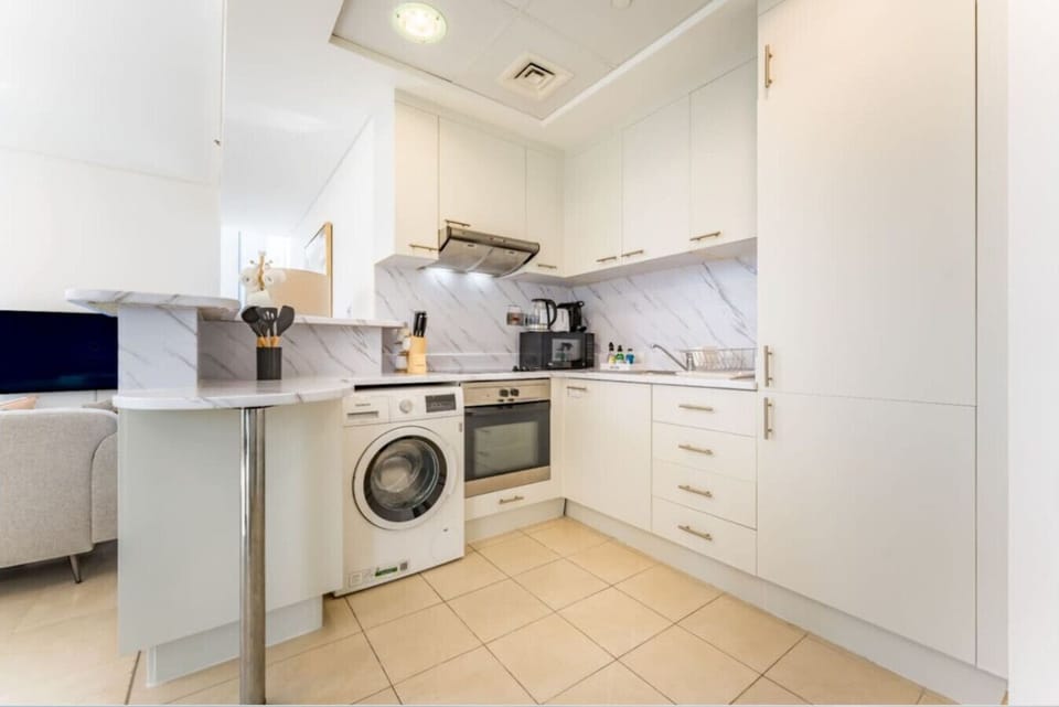 Kitchen: Sleek and modern kitchen featuring stainless steel appliances and stylish marble accents!