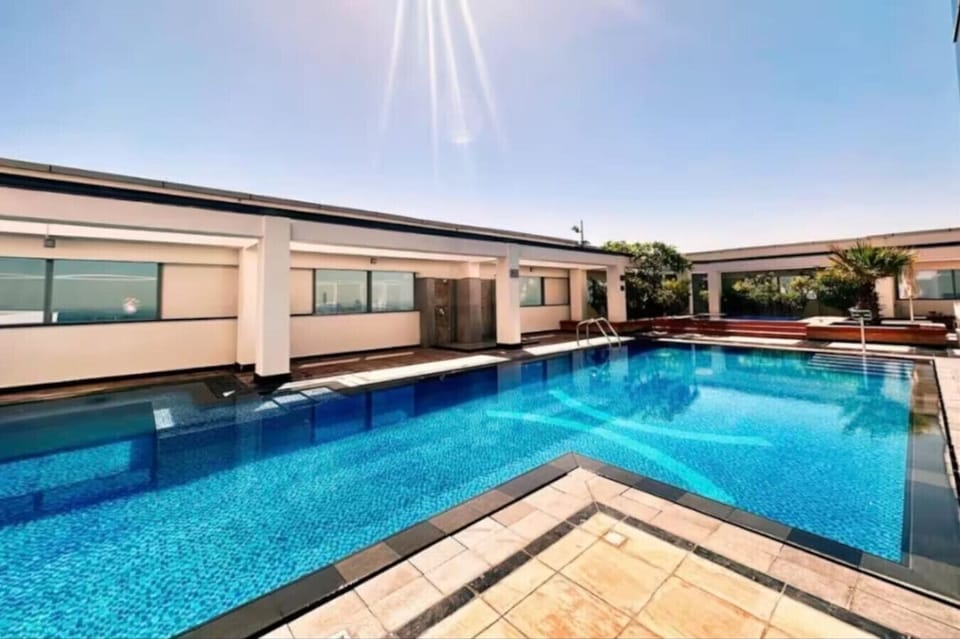 Rooftop Oasis: Dive into luxury at this stunning pool with panoramic skyline views!