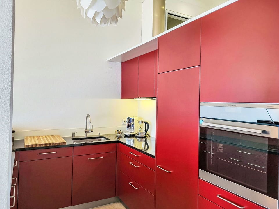Kitchen, Interior Design, Red, Flooring, Kitchen Appliance, Countertop, Cabinetry, Wood, Major Appliance, Floor
