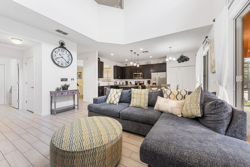 Relax in comfort with plush sofas, elegant décor, and direct access to the pool — perfect for cozy evenings and family movie nights.
