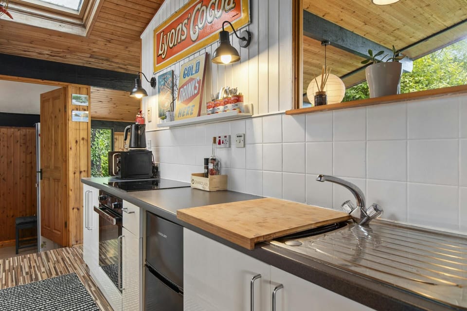 Induction hob, electric oven, microwave, kettle, sink and drainer