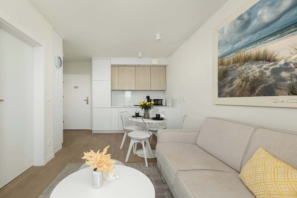 A stylish living room with a large corner sofa, coffee table, and Smart TV — ideal for unwinding after a busy day.