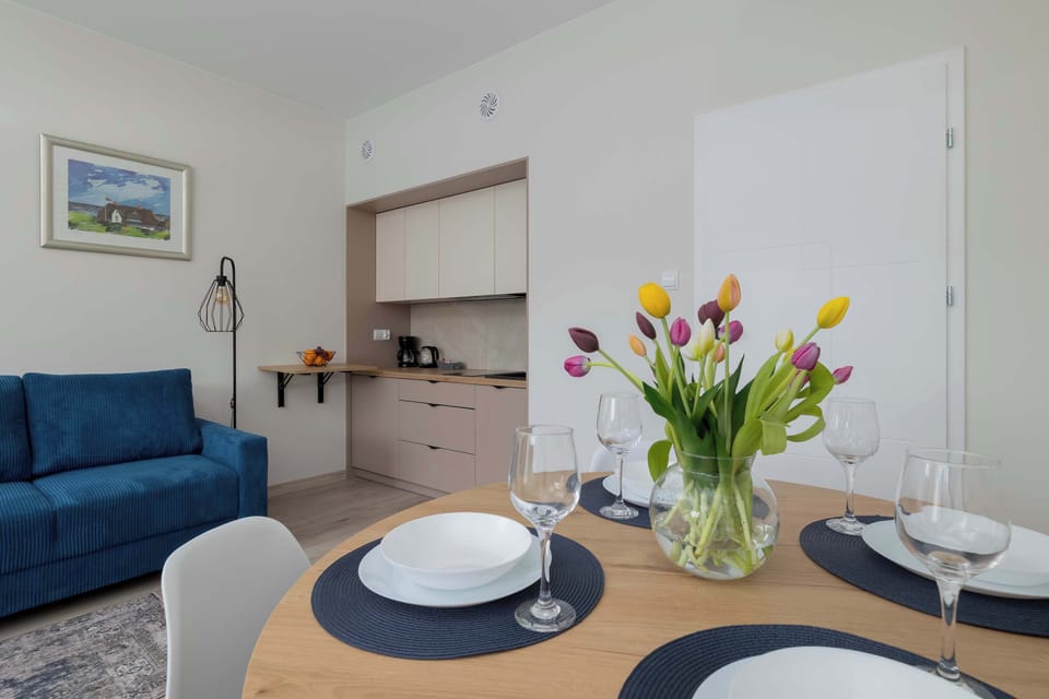 Modern kitchenette with white cabinetry, black fixtures, and essential appliances.