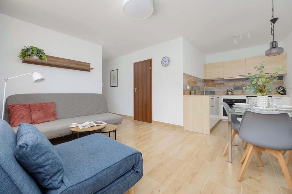 Bright and cozy living room with sofa beds, coffee table and access to the bedroom and hall.

