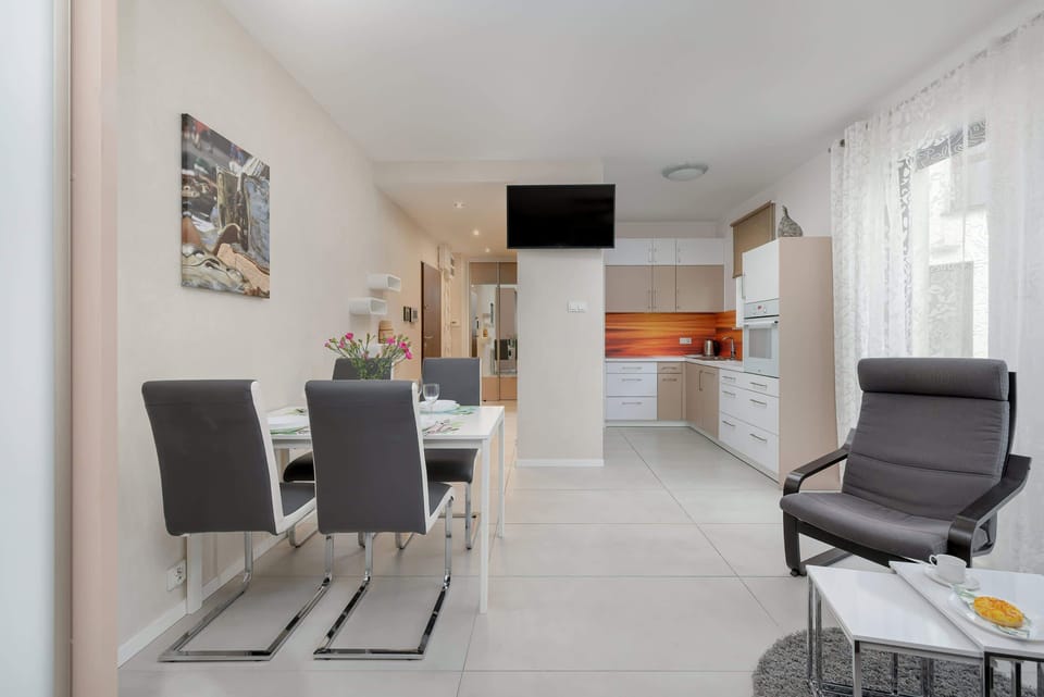 Another angle of the open-plan living area, showcasing a well-lit, modern interior with contemporary furniture and a sleek design.

