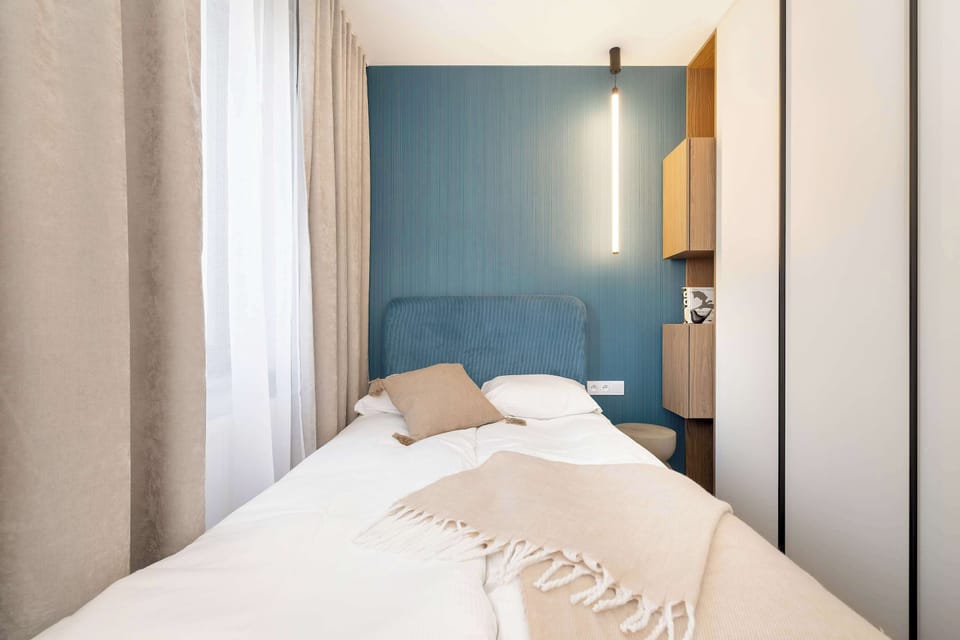 Enjoy the simplicity and comfort of the bedroom's modern design. 