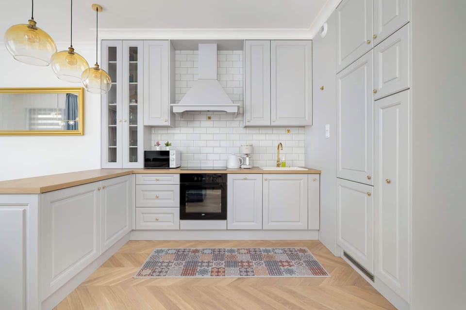 The sleek design of the kitchenette blending seamlessly with the living area.