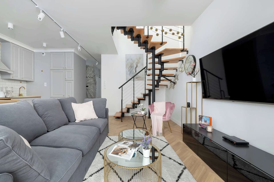 The elegant living room featuring a double sofa bed, perfect for relaxing or sleeping.