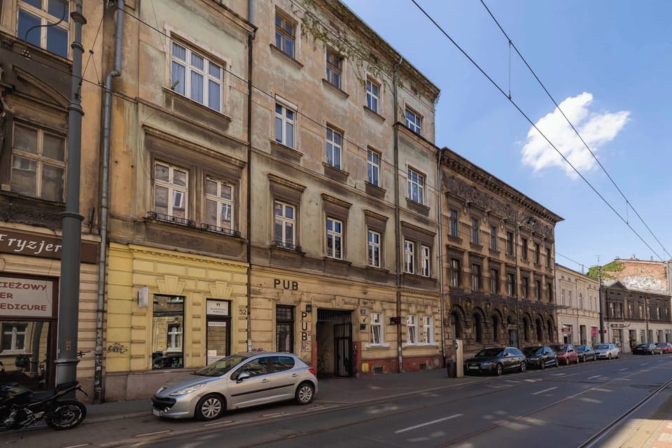 Exterior view of the apartment building, showing a charming street with historic architecture.