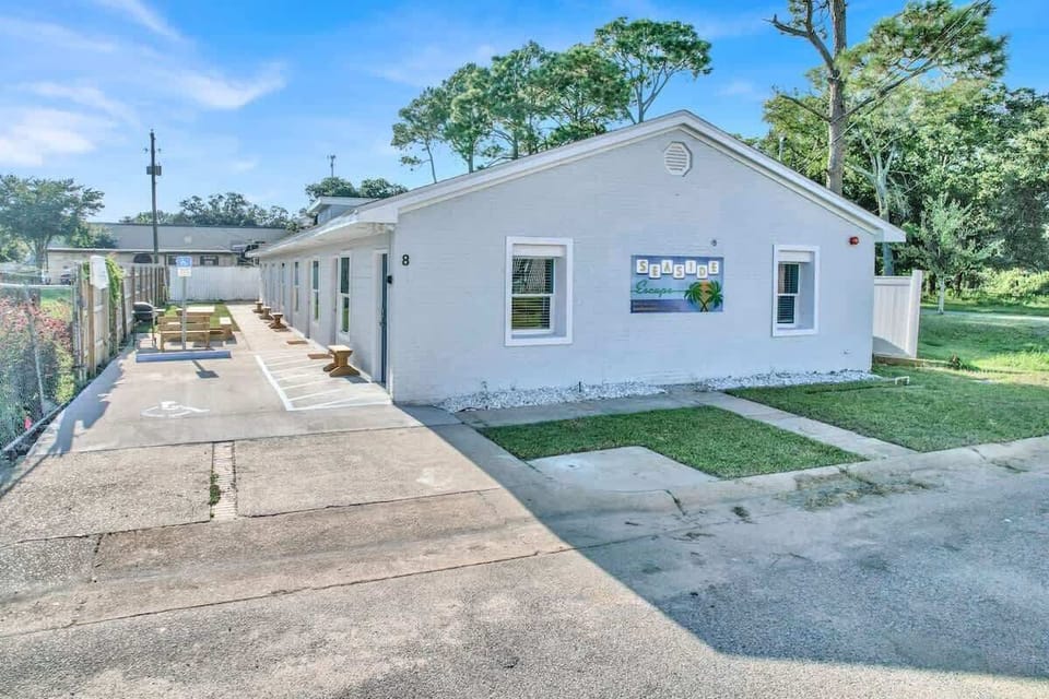 Property building with BBQ grill and outdoor seating area