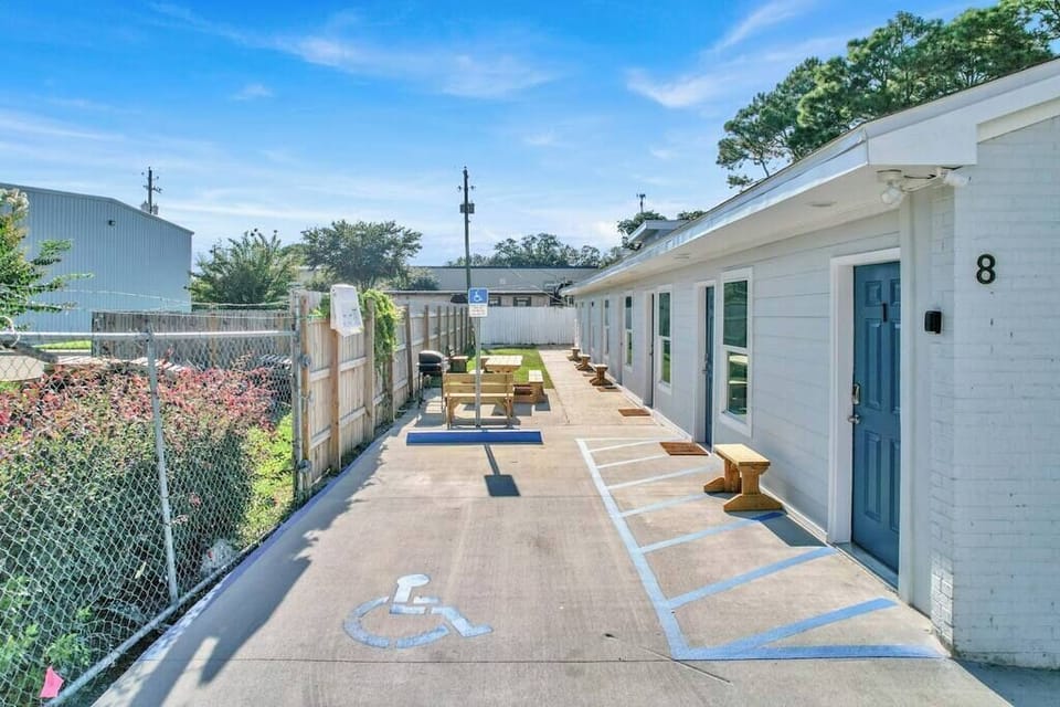 Property building with BBQ grill and outdoor seating area