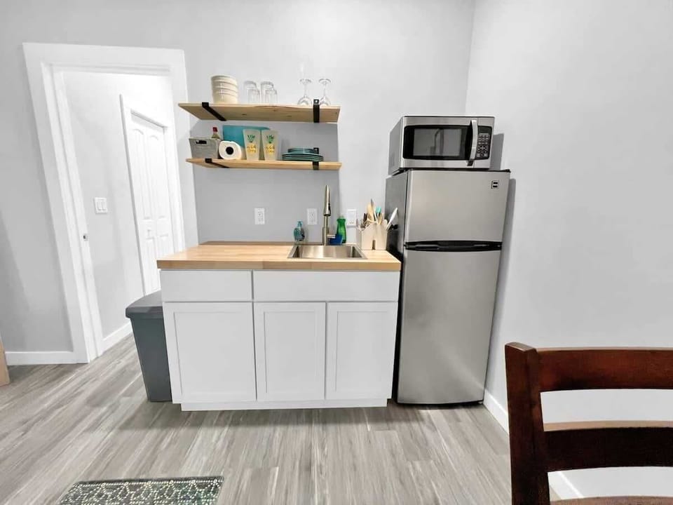 Kitchenette, complete with cookware, a two burner stovetop, fridge, freezer, and microwave!