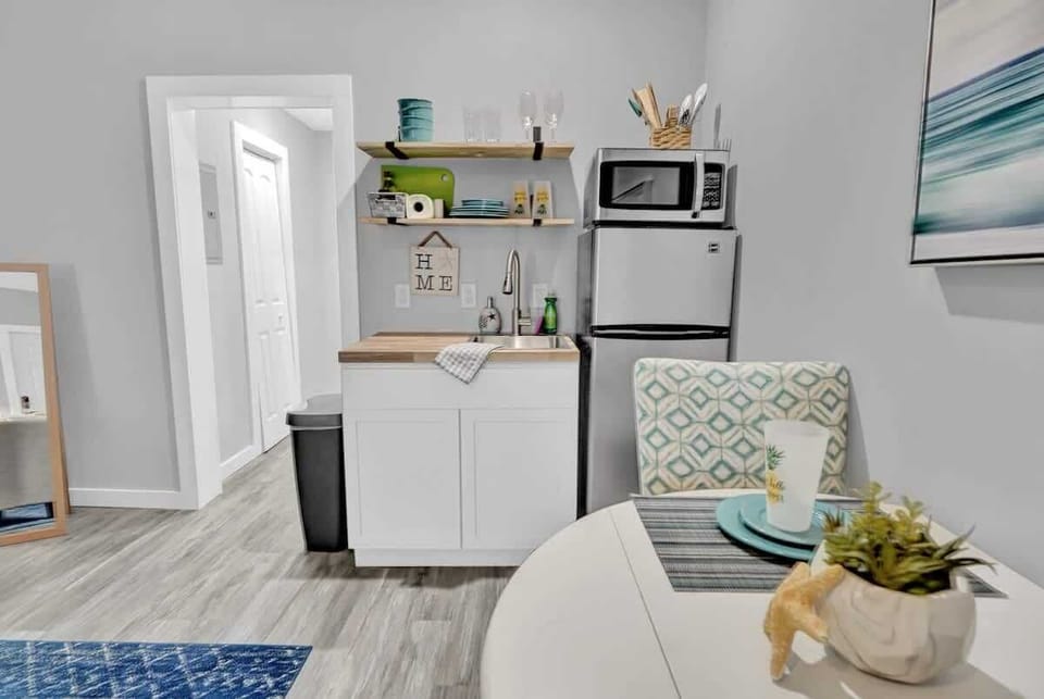 Kitchenette, complete with cookware, a two burner stovetop, fridge, freezer, and microwave!