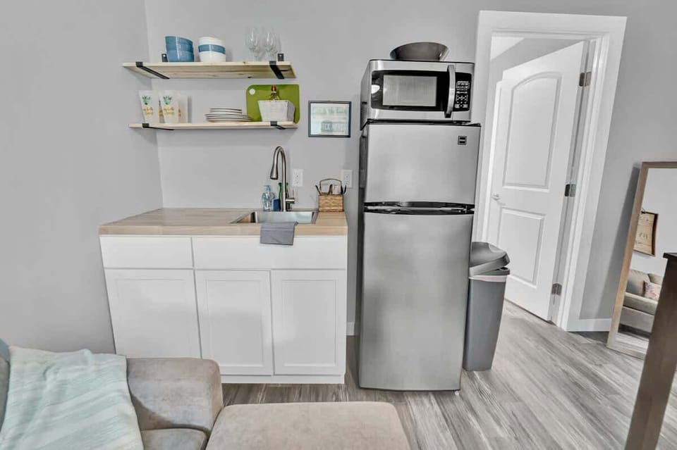 Kitchenette, complete with cookware, a two burner stovetop, fridge, freezer, and microwave!