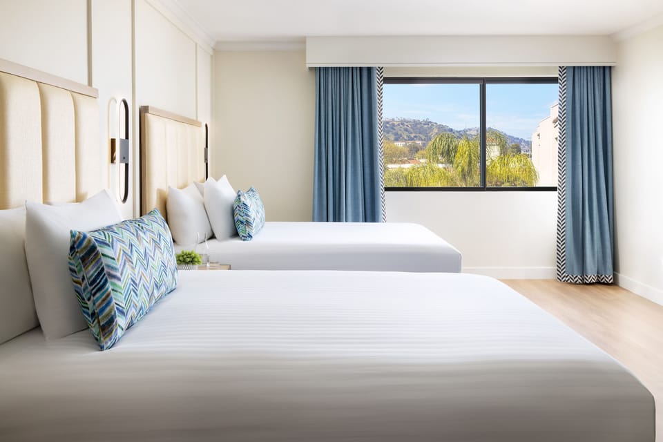 Breathe in morning light with hillside views from bed.