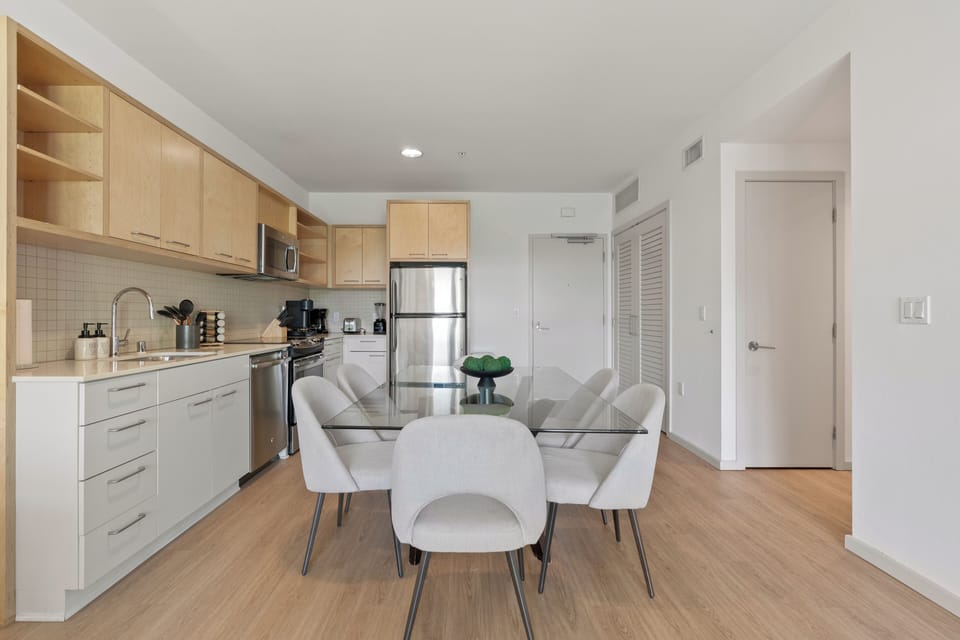 Kitchen is featuring stainless steel appliances and sleek quartz countertops