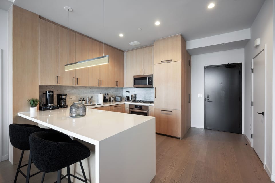 Fully equipped chef's kitchen with sleek, integrated stainless steel appliances.