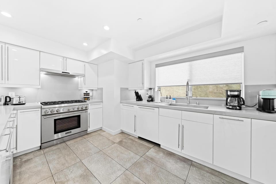 Spacious quartz island serves as a perfect gathering spot.