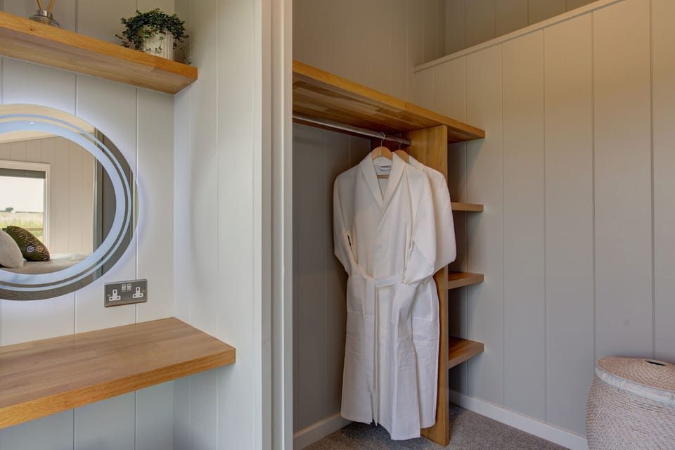 Ground floor: Clothes storage in an open wardrobe with shelving