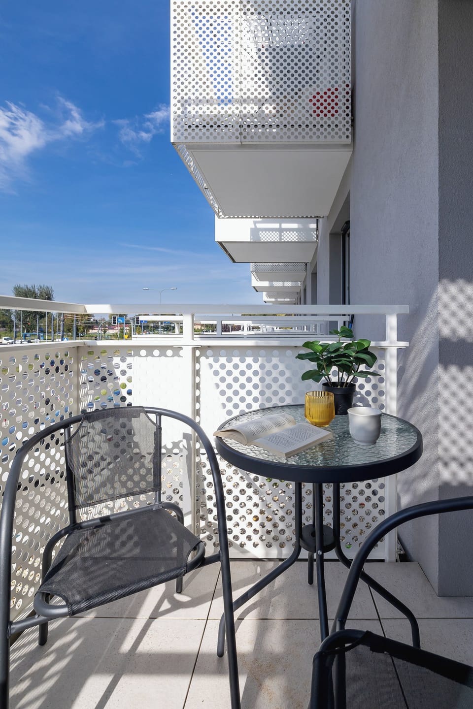 Equipped balcony with outdoor furniture.