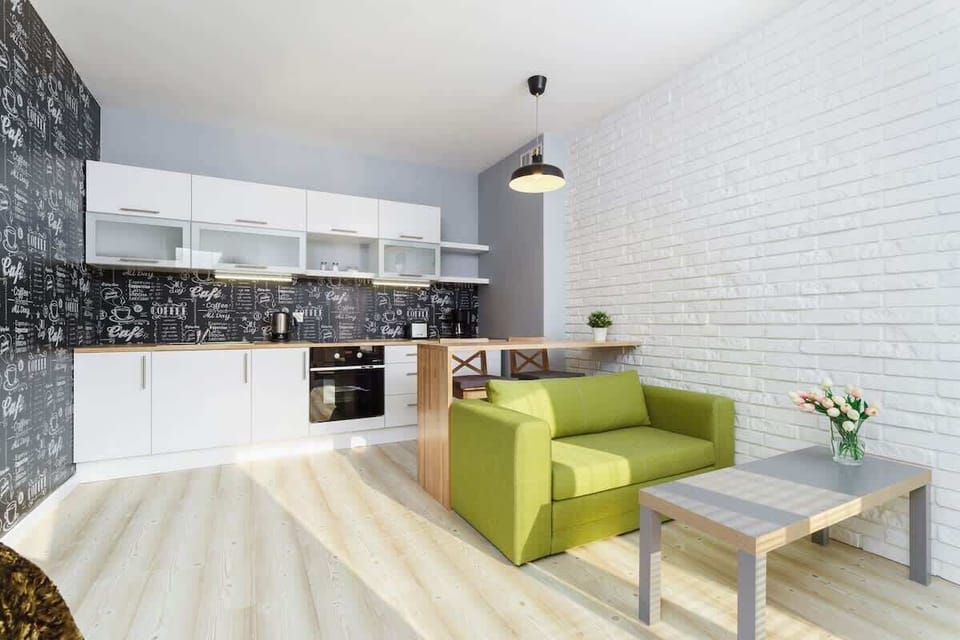 Another angle of the living room featuring the green sofa and a small coffee table.