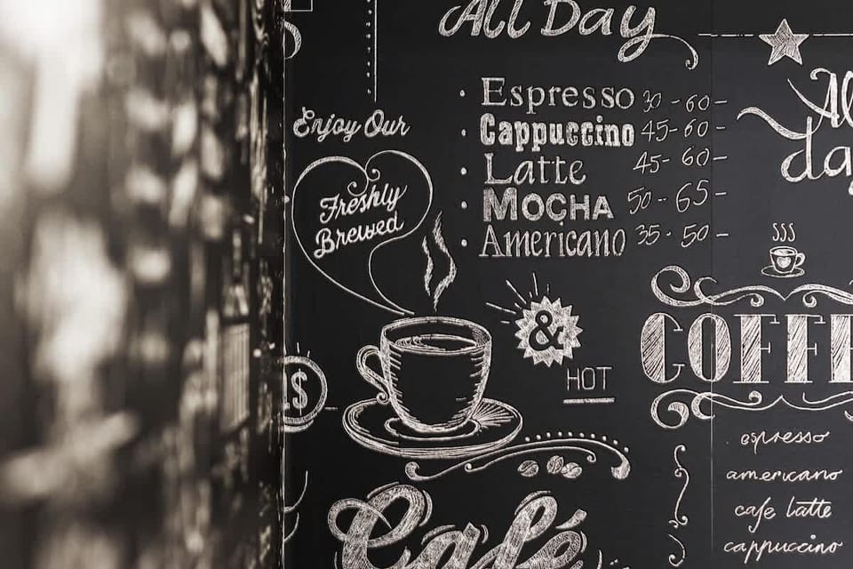 Close-up of the wall of the kitchenette. Black wall with white cups. 