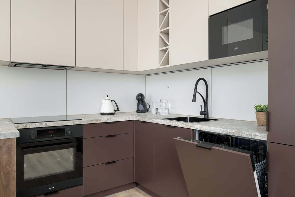 The sleek design of the kitchenette blending seamlessly with the living area.