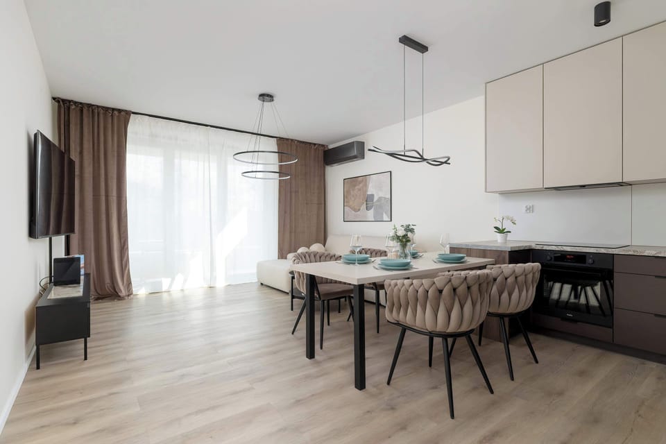 The elegant living room featuring a double sofa bed, perfect for relaxing or sleeping.