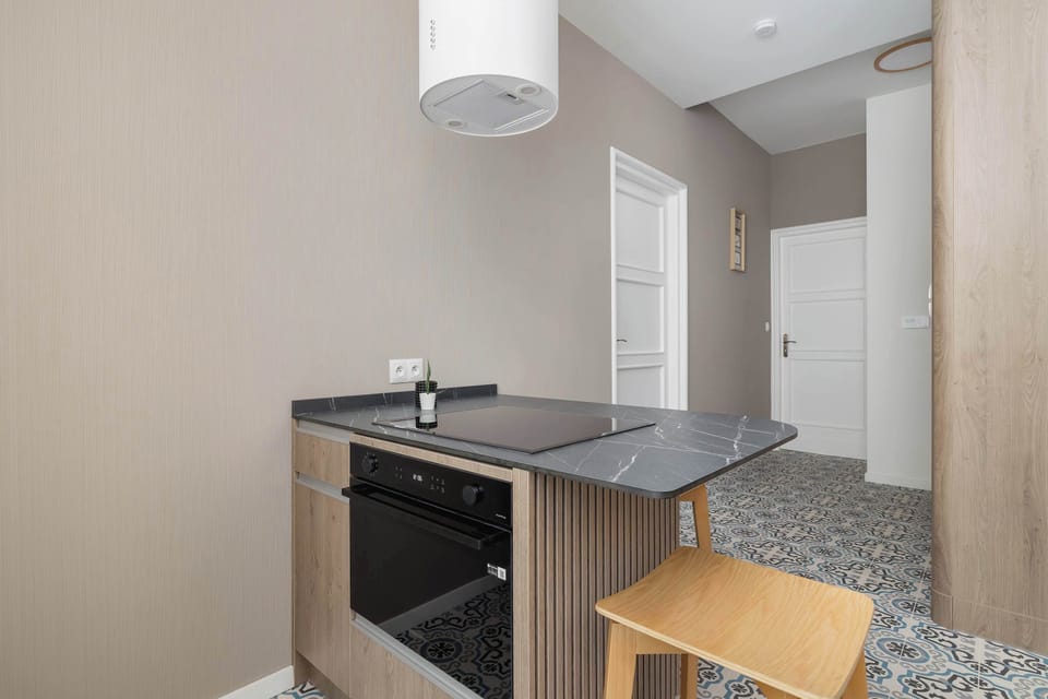 Independent kitchen with dining area and such appliances as coffee machine, and an oven with microwave function.