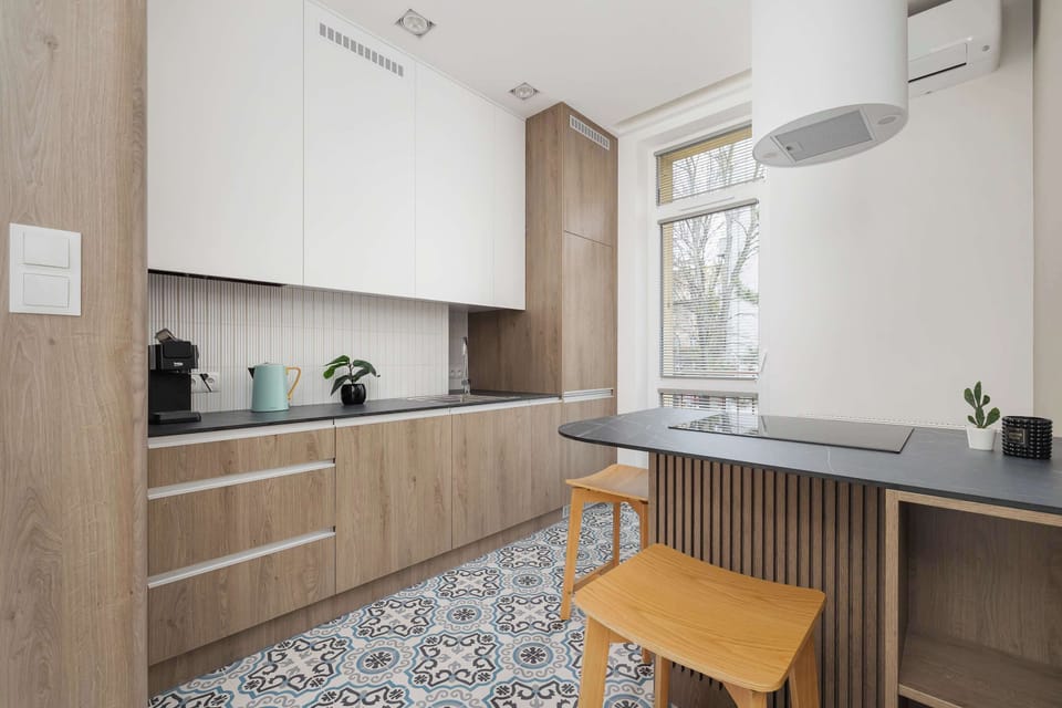 Separate kitchen with an oven with microwave function, a dining space, and electric kettle.