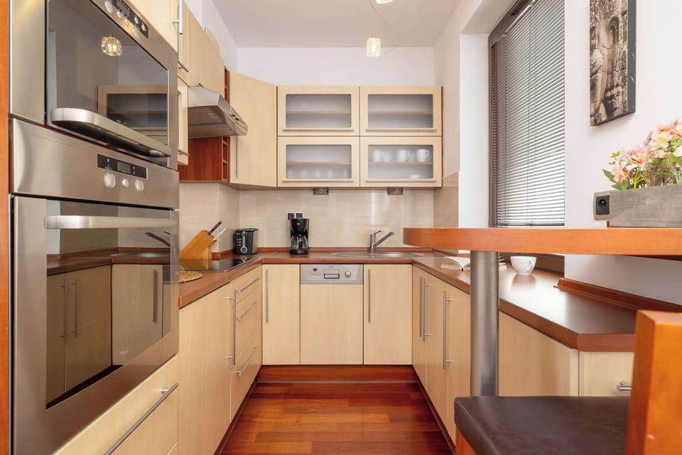 The fully equipped kitchen with an oven and generous countertop encourages cooking even elaborate meals.