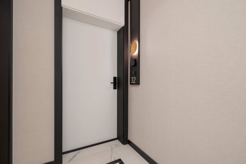 The white door leading into the flat.