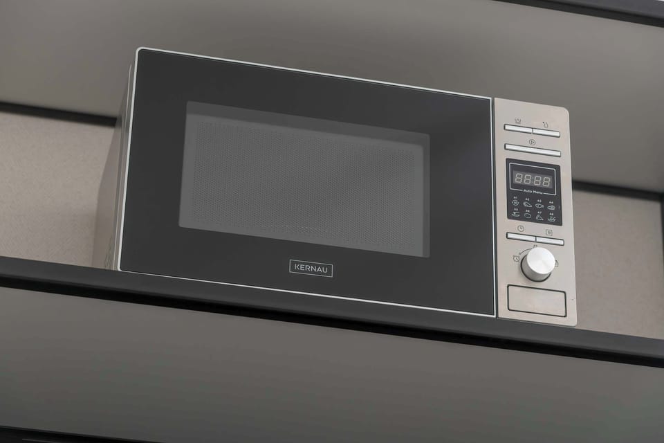 A detail shot of the built-in microwave in the kitchen, highlighting its sleek and modern design.