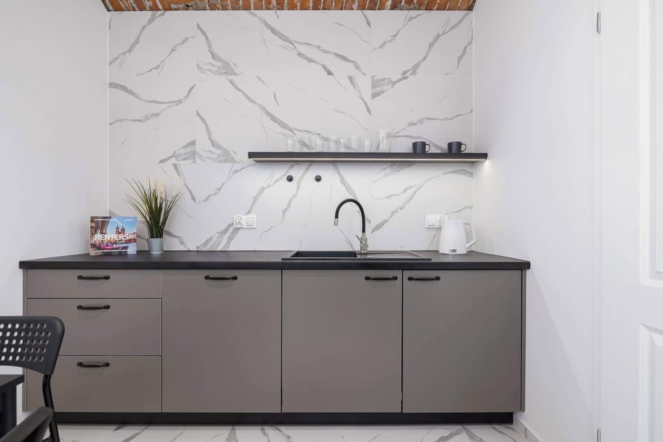The sleek kitchen with black accents offers full functionality in a stylish design.